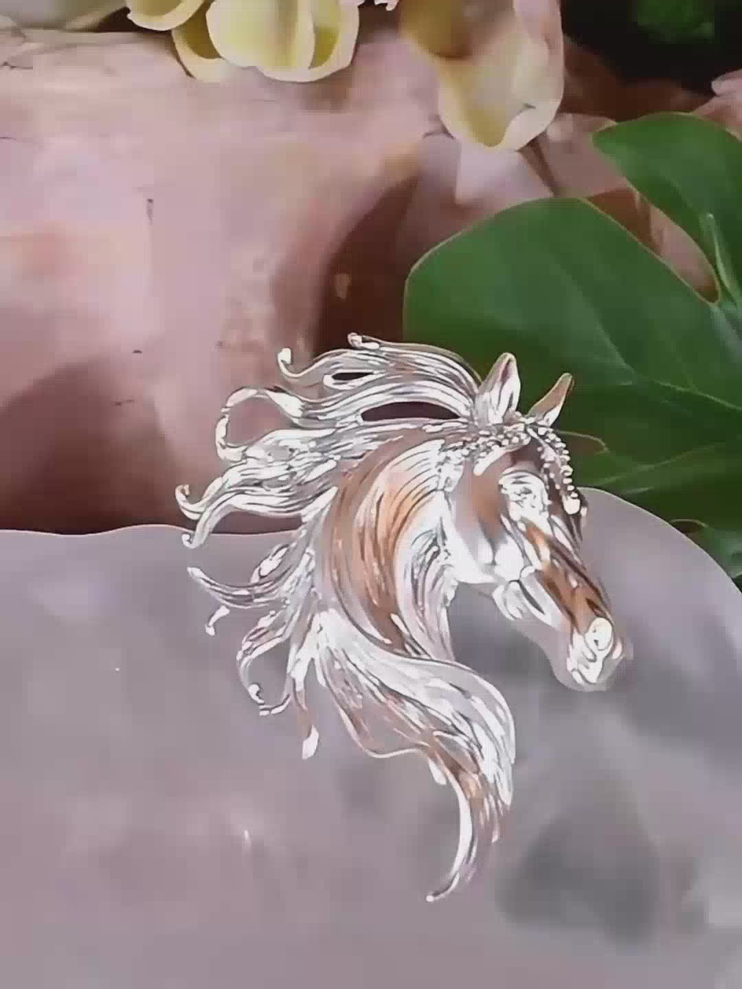 Jinherit The Gallant Spirit horse brooch pin detail video showing sculpted equestrian silhouette, flowing mane detail, gold or silver tone finish, and subtle CZ accents.