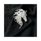 Silver-tone horse brooch on black fabric, highlighting sculpted mane texture and a refined equestrian silhouette.