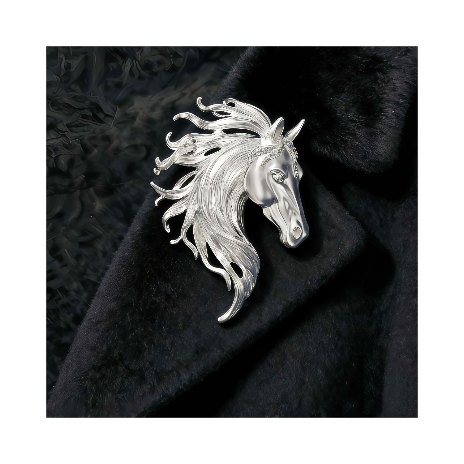 Silver-tone horse brooch on black fabric, highlighting sculpted mane texture and a refined equestrian silhouette.