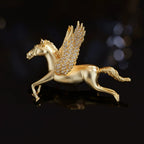 Gold-tone Pegasus brooch with sculpted winged horse form and pavé cubic zirconia accents.