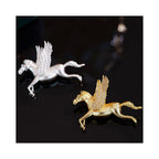 Close-up of Wings of Inspiration Pegasus pavé horse brooch in gold and silver tones, highlighting the sculpted flying horse form, feathered wings, and sparkling pavé detail.